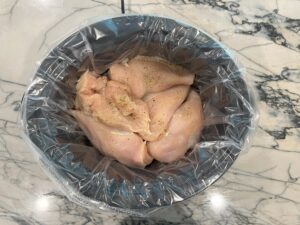 Dinner hack : cook chicken in crockpot to freeze for later